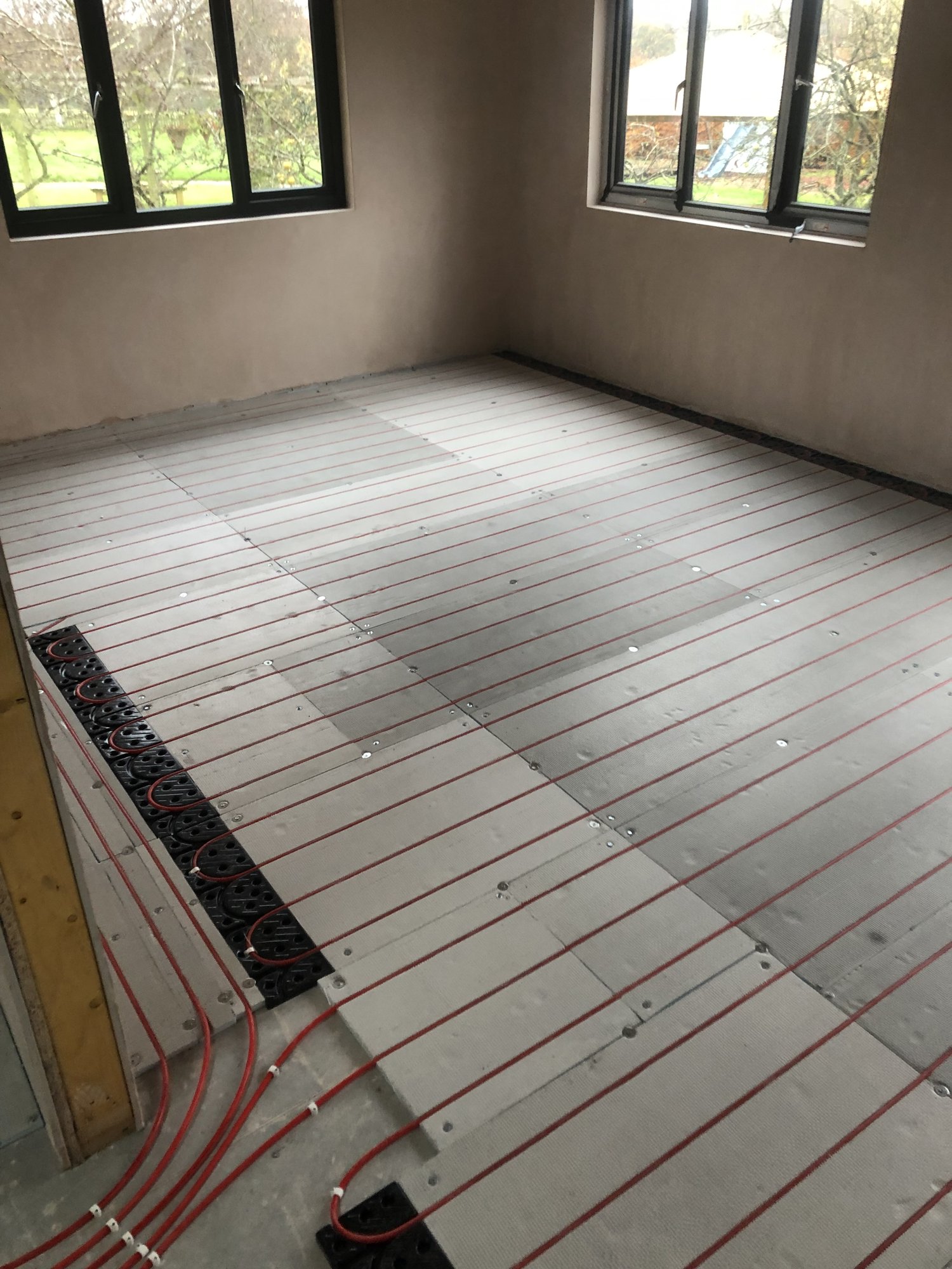 Underfloor heating pipework being laid
